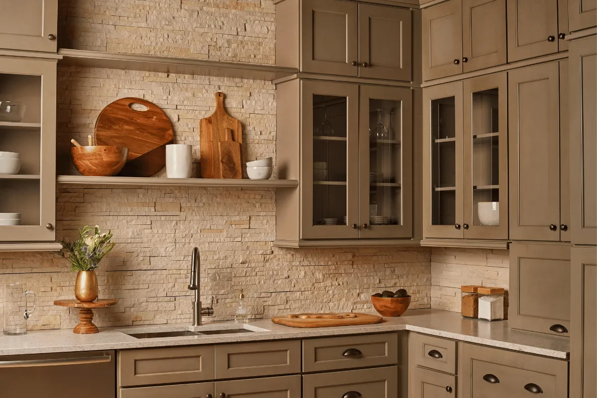Warm cabinetry with textured stone backsplash and glass display cabinets