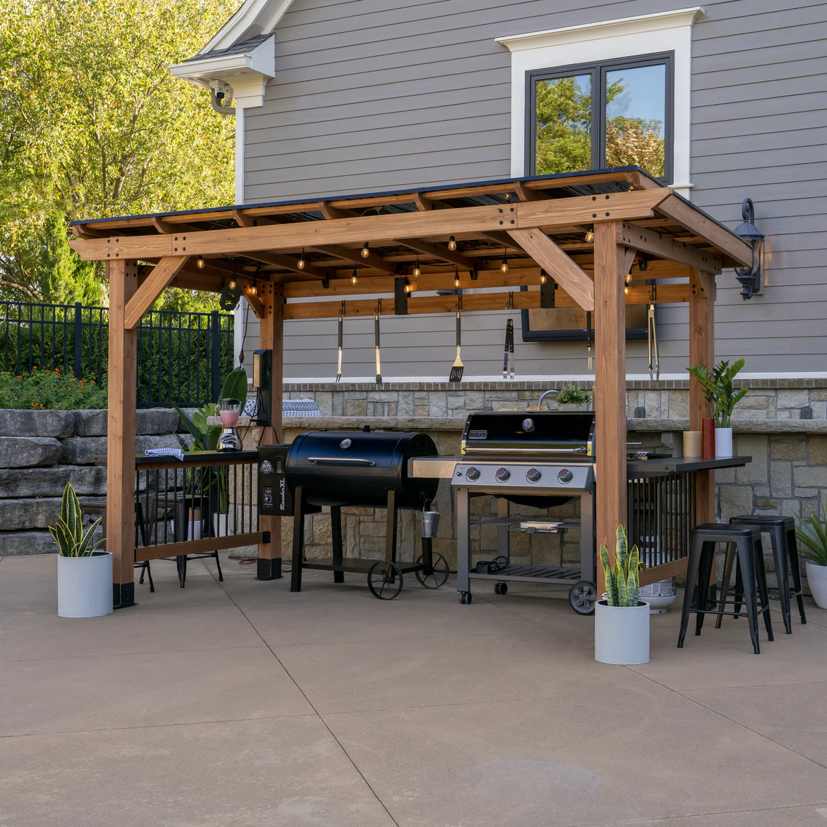 Outdoor kitchen with pergola and grills